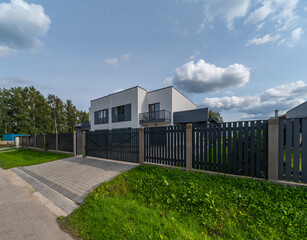 Modern exterior of luxury private house. External fence.