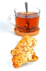  a cup of tea with tasty croissants