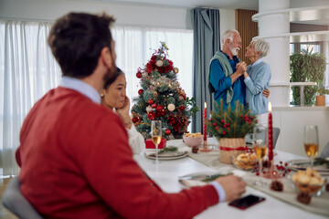 a beautiful mature couple dancing at home for Christmas