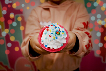 girl holding a festive cupcake in her hands. holiday new year, christmas.