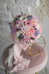 Stylish bridal bouquet of preserved flowers. Wedding bouquet of white and pink roses. Close up of wedding bouquet.