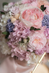 Stylish bridal bouquet of preserved flowers. Wedding bouquet of white and pink roses. Close up of wedding bouquet.