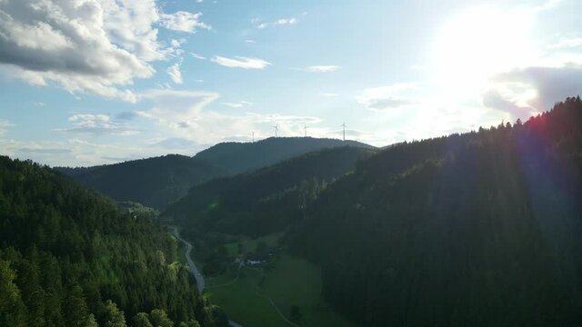Drone fly in the evening to the windmills