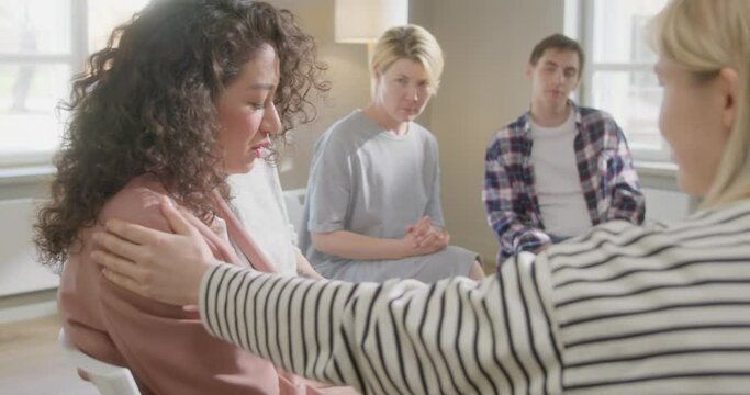 Woman and Patients Embracing Giving Psychological Support During Group Therapy Counseling Session, Ladies Hug Sit in Circle Feel Relief Empathy Helping Friend at With Problems Addiction
