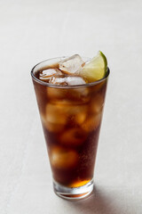 Alcoholic cocktail of rum with ice and lime, close-up, macro photography.
