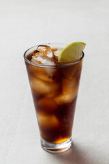 Alcoholic cocktail of rum with ice and lime, close-up, macro photography.