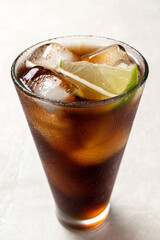 Alcoholic cocktail of rum with ice and lime, close-up, macro photography.
