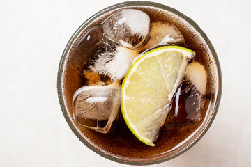 Alcoholic cocktail of rum with ice and lime, close-up, macro photography.