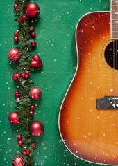 Acoustic guitar and beautiful red Christmas decoration on green background. Christmas, New year...