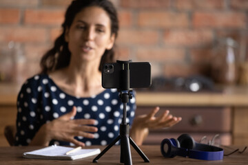 Broadcasting live. Young hispanic woman business coach teacher mentor speak before cellphone webcam...