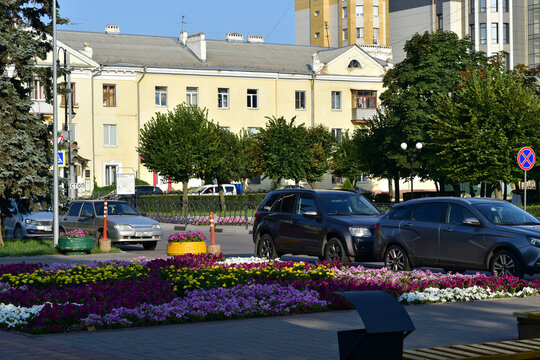 The city of Tambov, Russia. 08. 18. 2021. The picture shows one of the streets of the city. Numerous flower beds and parked cars along the road.