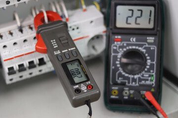 Measurement of parameters of electrical devices in the electrical panel using a multimeter.