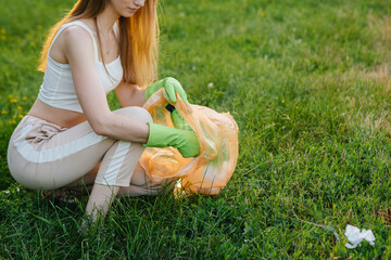 A group of girls with children at sunset are engaged in garbage collection in the park....