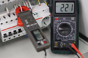 Measurement of parameters of electrical devices in the electrical panel using a multimeter.