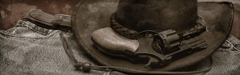 jean, chapeau de cuir et revolver - obrazy, fototapety, plakaty