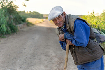 Close up of happy farmer in a field at the sunset