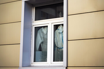 Doctors' protective suits against Covid-19 hang on a window in a closed sector of the hospital.