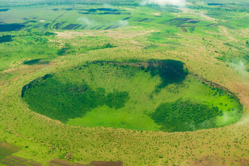 Green Volcanic crater from above in the Serengeti National Park near Arusha, Tanzania - obrazy, fototapety, plakaty