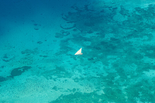 Faluka sailing the Indian Ocean from above near Stonetown, Zanzibar, Tanzania