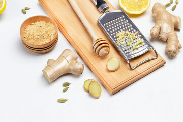 Grater with grated ginger. Stick with honey on board.