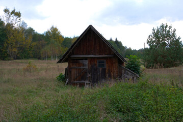 Autumn day. The hut on the edge of the forest.