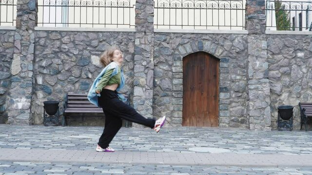 dancing woman breakdancing hip hop dancer practicing dance routine performing freestyle moves in city