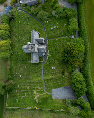 Cemetery grounds of Avon Gifford St Andrew's. An old cruciform church building in Devon, UK. Drone aerial view