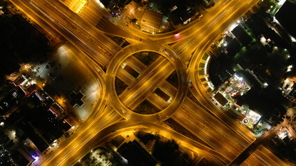 Aerial drone night slow shutter shot of urban ring multilevel interchange highway road passing through city centre