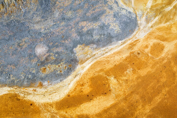 Grey and yellow colors of copper mine tailings. Abstract natural texture, drone view directly above