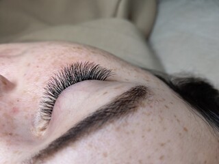 Naklejka premium Lash extensions in beauty salon macro eye 