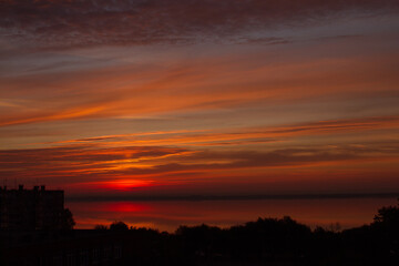 red-orange sunrise over the lake