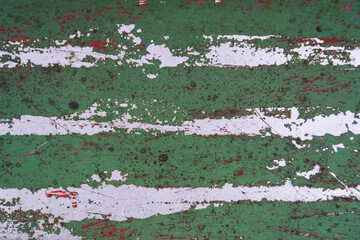 Old green metal sheet. There are white parallel frayed streaks and scratches. Background. Texture.