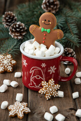 Obraz na płótnie Canvas Mug with hot chocolate and gingerbread cookies on wooden table