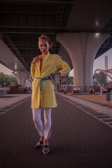 Portrait of a young beautiful girl in yellow jacket on a warm summer evening