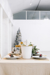 A bucket of champagne on a festive set table for the celebration of Christmas or New Year