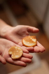small pancakes in the hands of a child