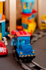 a toy railway with a train and a little man