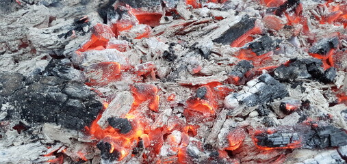 Hot coals and ash. Hot firewood in the grill. Grilling coals.