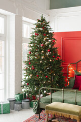 Beautiful Christmas tree with lights in the red classic bedroom near the window