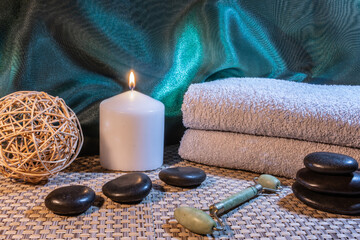 Spa, zen basalt stones, towels, candles in the massage room.