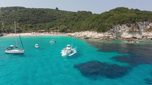 Aerial view of speed boat leaving the exotic Vrika beach at Paxos island Greece