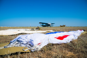Parachutes are laid out on the ground before a skydiving competition