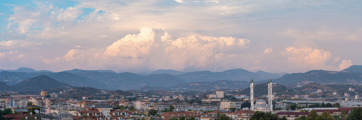 Panorama view over Turkish city with mosque and dramatic sky