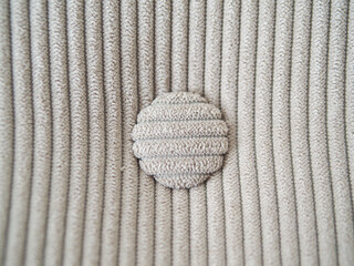 Beige velvet material with vertical lines and round buttons