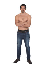 man shirtless and with blue jeans, arms crossed and looking at camera on white background