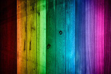 texture from wooden boards of different species in the colors of the spectrum with darkened edges, blurred image
