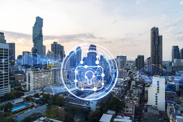 Fototapeta na wymiar Hologram of Padlock on sunset panoramic cityscape of Bangkok, Southeast Asia. The concept of cyber security intelligence. Multi exposure.