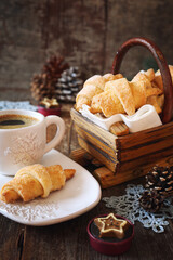 Cottage cheese croissants, cup of coffee and New Year's decoration