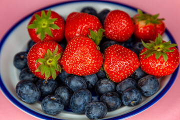 strawberries and blueberries on a plate