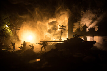 Fototapeta premium War Concept. Military silhouettes fighting scene on war fog sky background, World War Soldiers Silhouette Below Cloudy Skyline At night. Battle in ruined city.